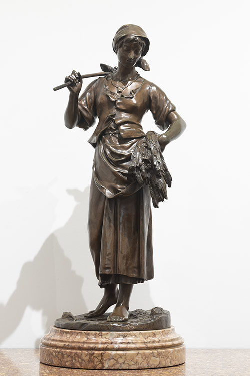 Bronzen beeld van boerin die tarwestengels naleest.